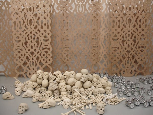  to Chris Cozier and noting the pile of skulls in Pinas's installation
