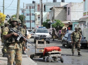 Gleaaner: Soldiers stand guard at an entrance into Tivoli Gardens during the May 2010 incursion into the volatile community - file photo. Town - File.
